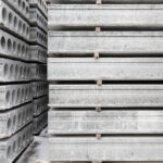Stack,Of,Prefabricated,Concrete,Slabs,With,Hole,For,Construction.